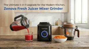 Atomberg Zenova Fresh 4-in-1 juicer mixer grinder on a kitchen counter, featuring the black motor base, a clear jar pouring red juice, and a bowl of finely chopped carrots next to a stainless steel jar