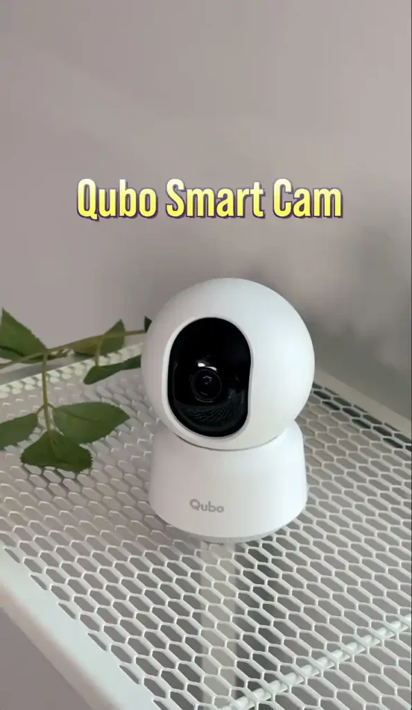Qubo Smart Cam 2026 indoor security camera placed on a white mesh shelf during hands-on review.