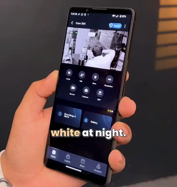 Smart security camera mobile app displaying black-and-white night surveillance footage during nighttime testing.